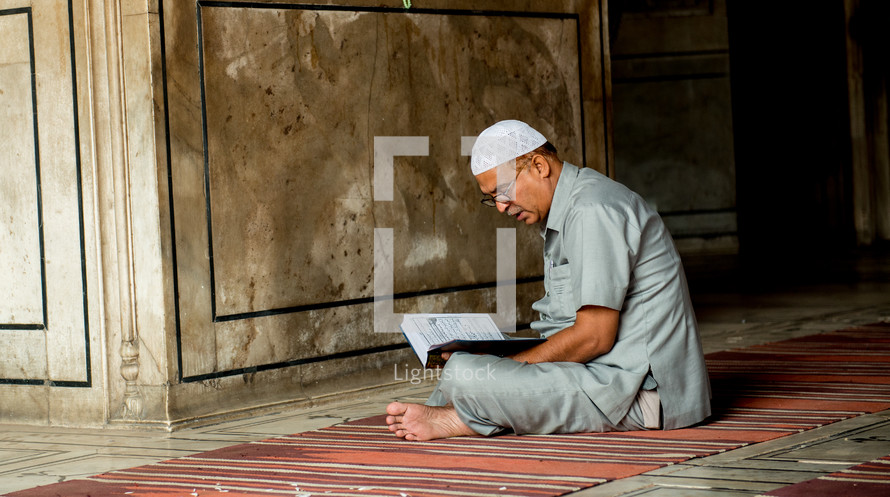 a man praying in a mosque in Delhi, India 