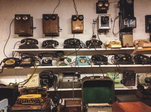 shelves of antique phones and typewriters 