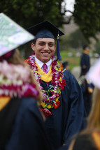 a happy graduate in a Hawaiian leis 