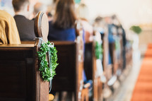 church pews decorated for a wedding 