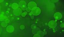 St. Patrick's Day abstract green bokeh light orbs background design element with copy space