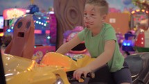 A boy in a game zone on a motorcycle simulator