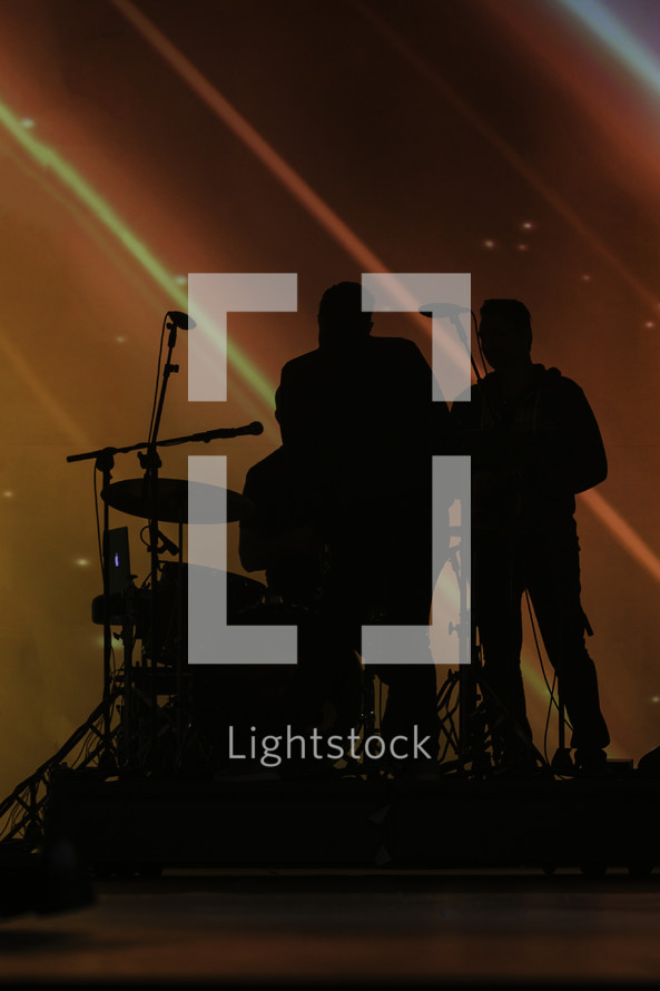 silhouette of a band on stage
