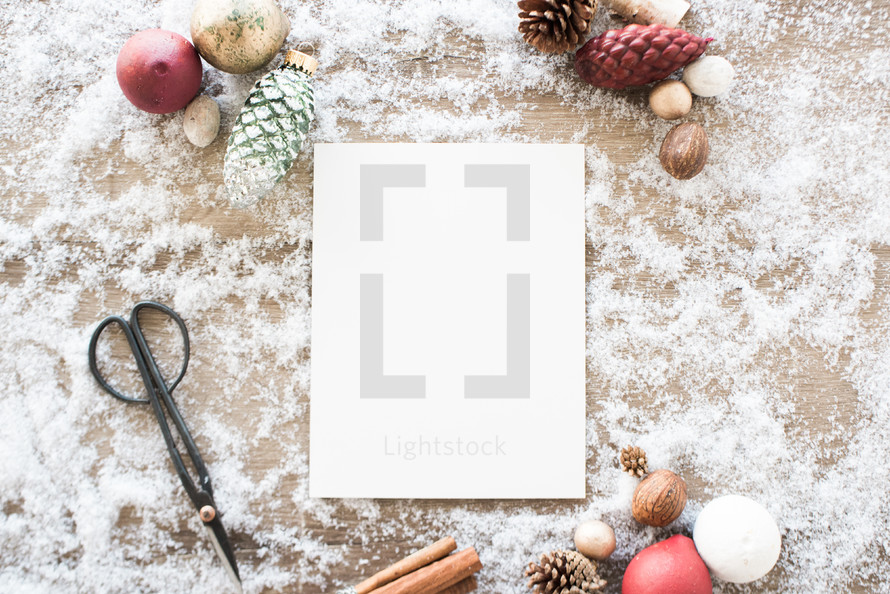 white paper and festive items in snow 