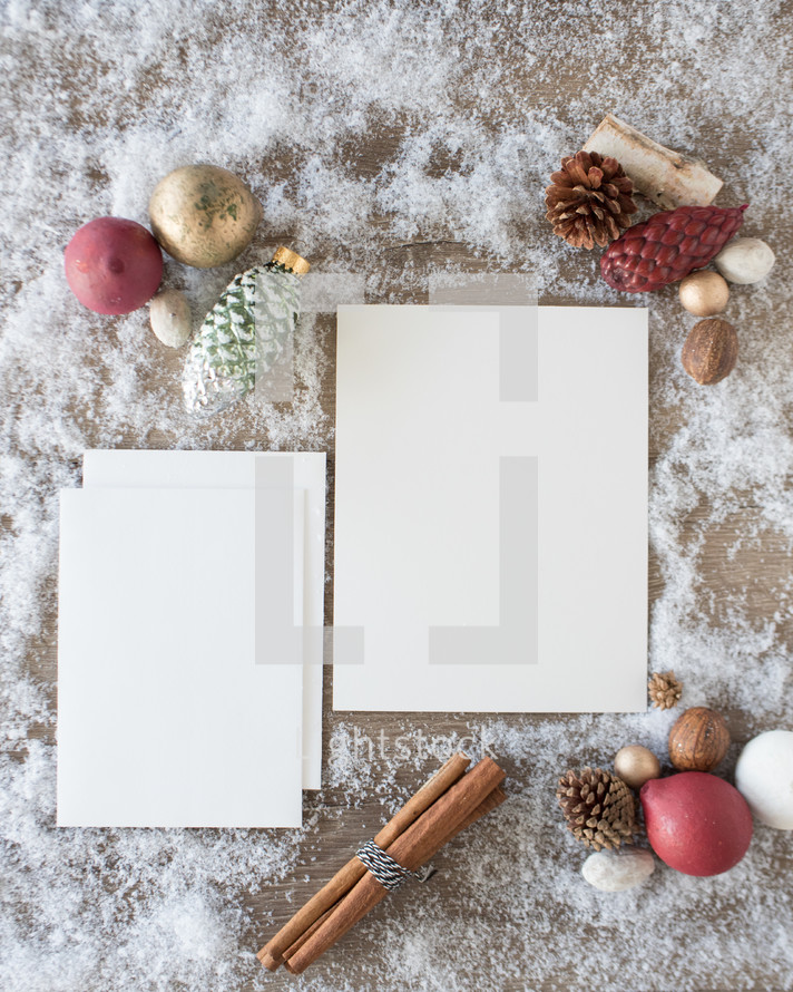 envelopes and white paper on snow with festive holiday border 