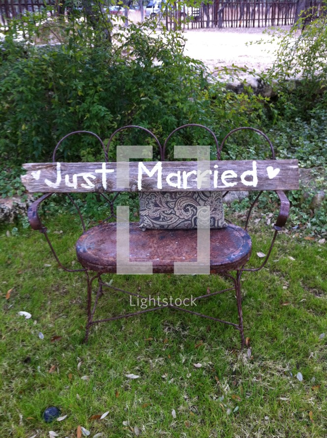 "Just Married" wood sign on chair