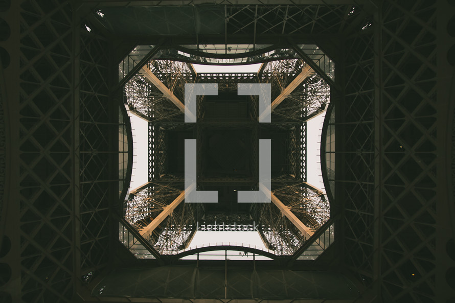 looking up through the center of the Eiffel tower 