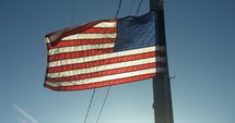 American, USA flag blowing in the wind in slow motion on 4th of July, United States Independence Day.