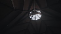 A panning shot of the skylight of a Catholic church. 