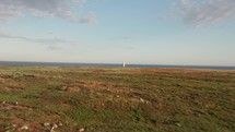 Aerial Approach to Lighthouse on Island at Sunset