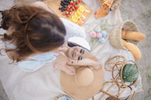 a woman having a summer picnic looking in a mirror 