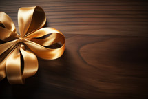 AI Generated Image. High angle view on the golden ribbon bow on a wooden table