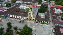 Aerial shot drone full orbit around bell tower on church at main square