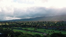 sun rays peaking through clouds in Maui Hawaii.