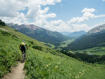 mountain biking up a trail 