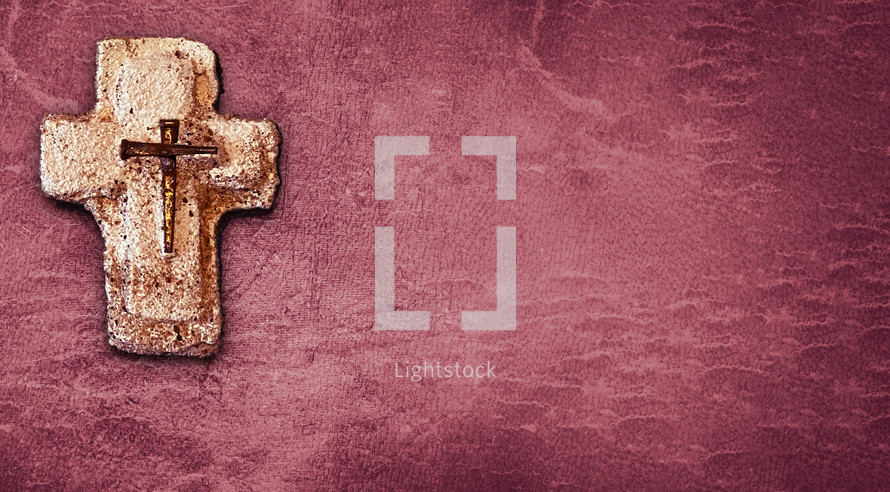 handmade sand cast cross with metal nails, off-center leaving room for text on the distressed muted red background