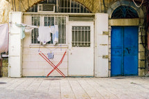 Clothesline outside of home with blue doors in Jeruselum