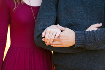 engaged couple holding hands 