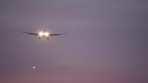 Commercial aircraft coming in to land at twilight
