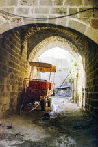 Stone archway with buggy in Israel
