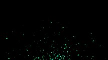 Green sparkles rise on black background