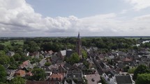 Aerial orbiting over Protestant Church in Loenen Aan De Vecht, Scenic tower in village donwtown, Utrecht 