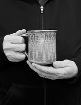 hands of a man holding a mug - black and white photo
