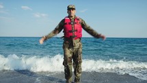 Military man training jump on the shore