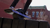 a person riding a one wheel skateboard 