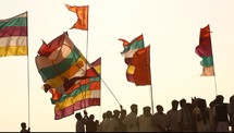 men holding colorful flags