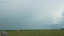 Farmland landscape with distant thunderstorm in rural America.