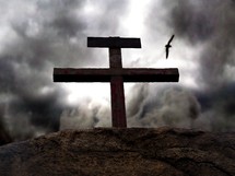 Dark skies gather around the rugged, bloodied cross on Gogatha where Jesus died on the cross for the sins of mankind. 