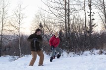 men having a snowball fight 
