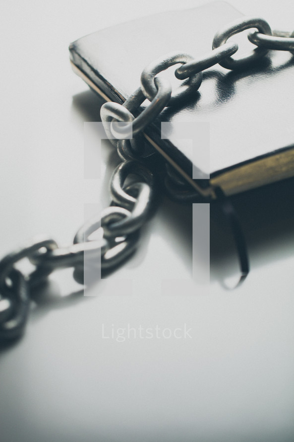 Chain links over a Bible.