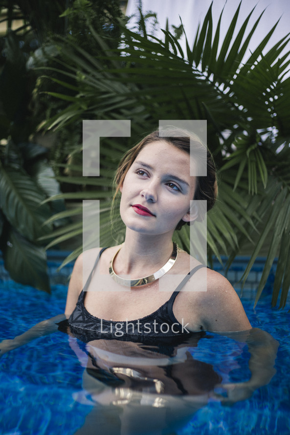 a woman in a swimming pool posing 