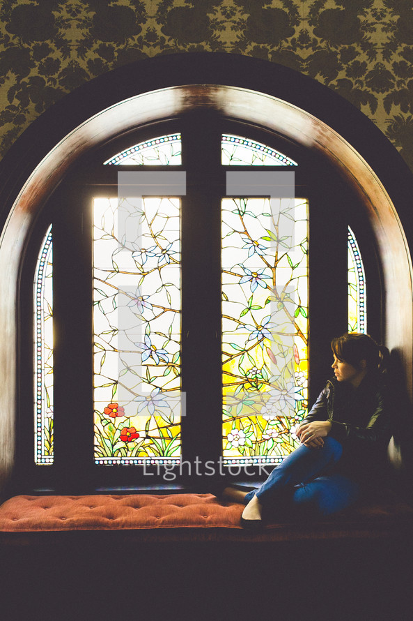 woman sitting in a window 