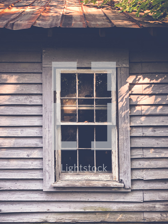 old window and red tin roof 
