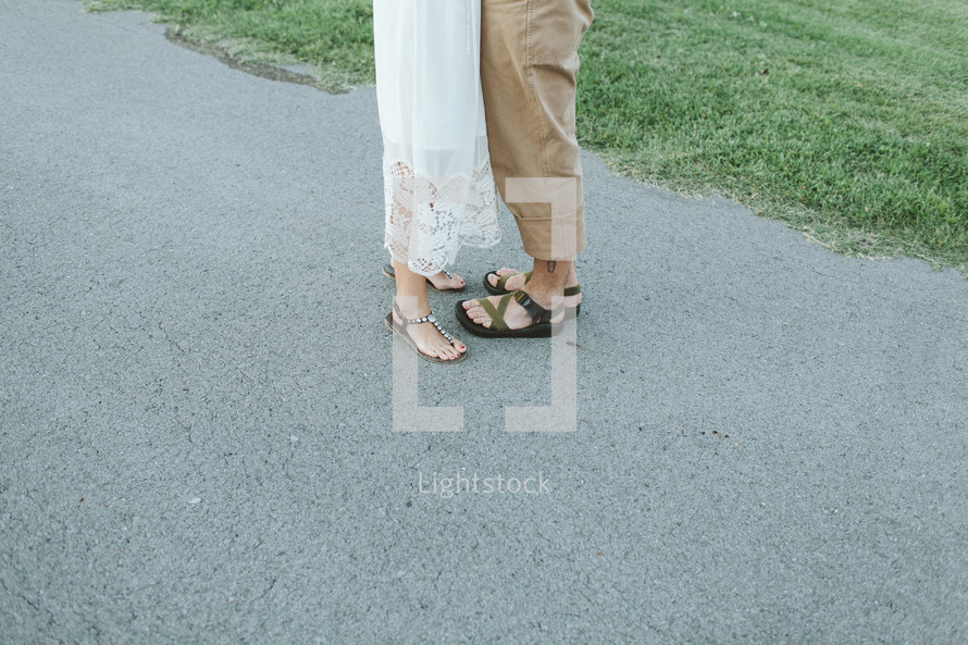 couples feet in sandals 