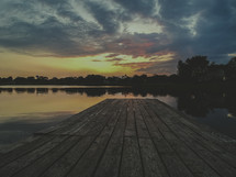dock over a lake at sunset 