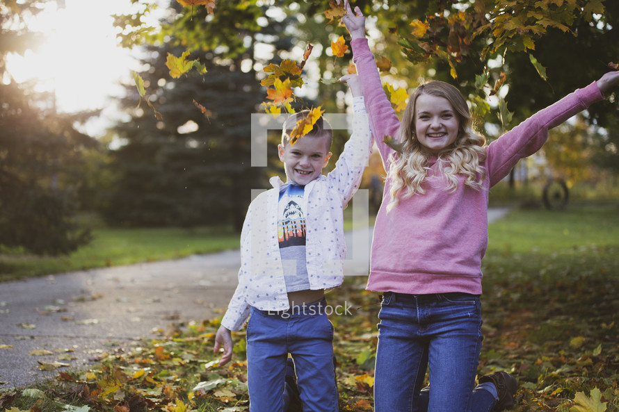 brother and sisters outdoors in fall 