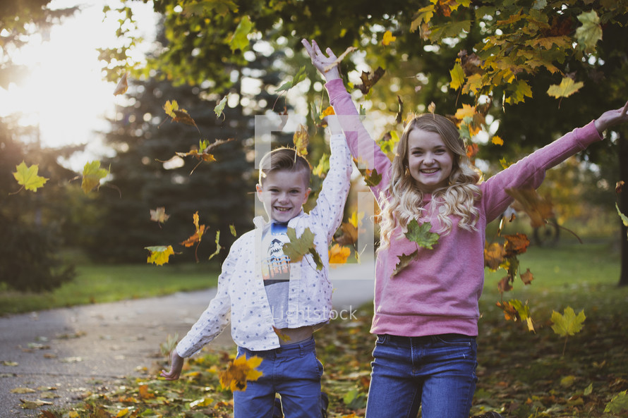 brother and sisters outdoors in fall 
