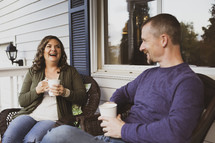 husband and wife having coffee on the front porch 
