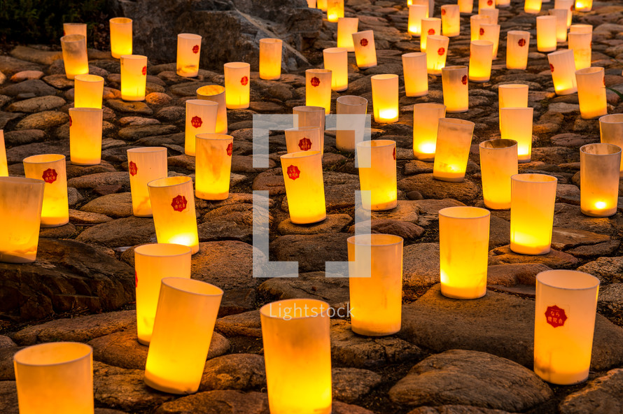 Lit candles on rocks at the Nara Candle Festival.