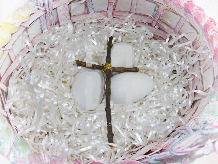 An Easter basket with a cross made out of sticks and eggs