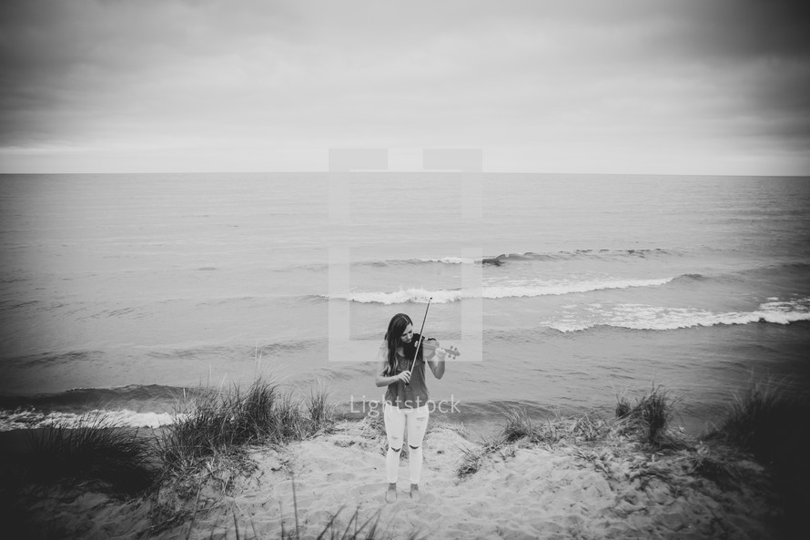 girl with a violin on the beach 