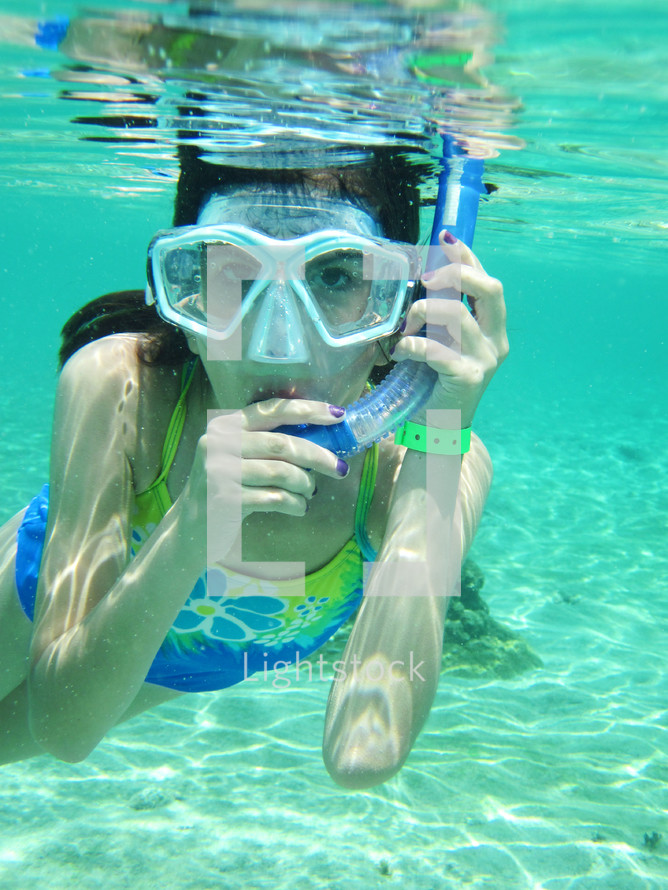 Woman under water with snorkeling gear on