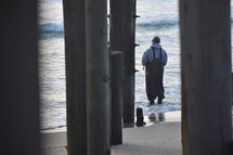 man fishing on a beach 