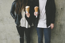 a couple holding ice cream cones 