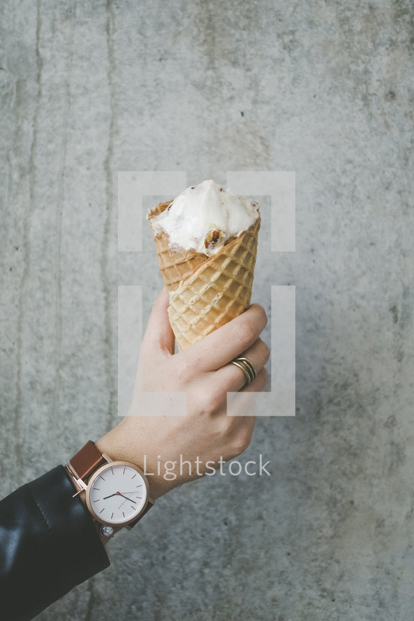 a man holding an ice cream cone 