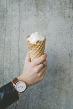 a man holding an ice cream cone 